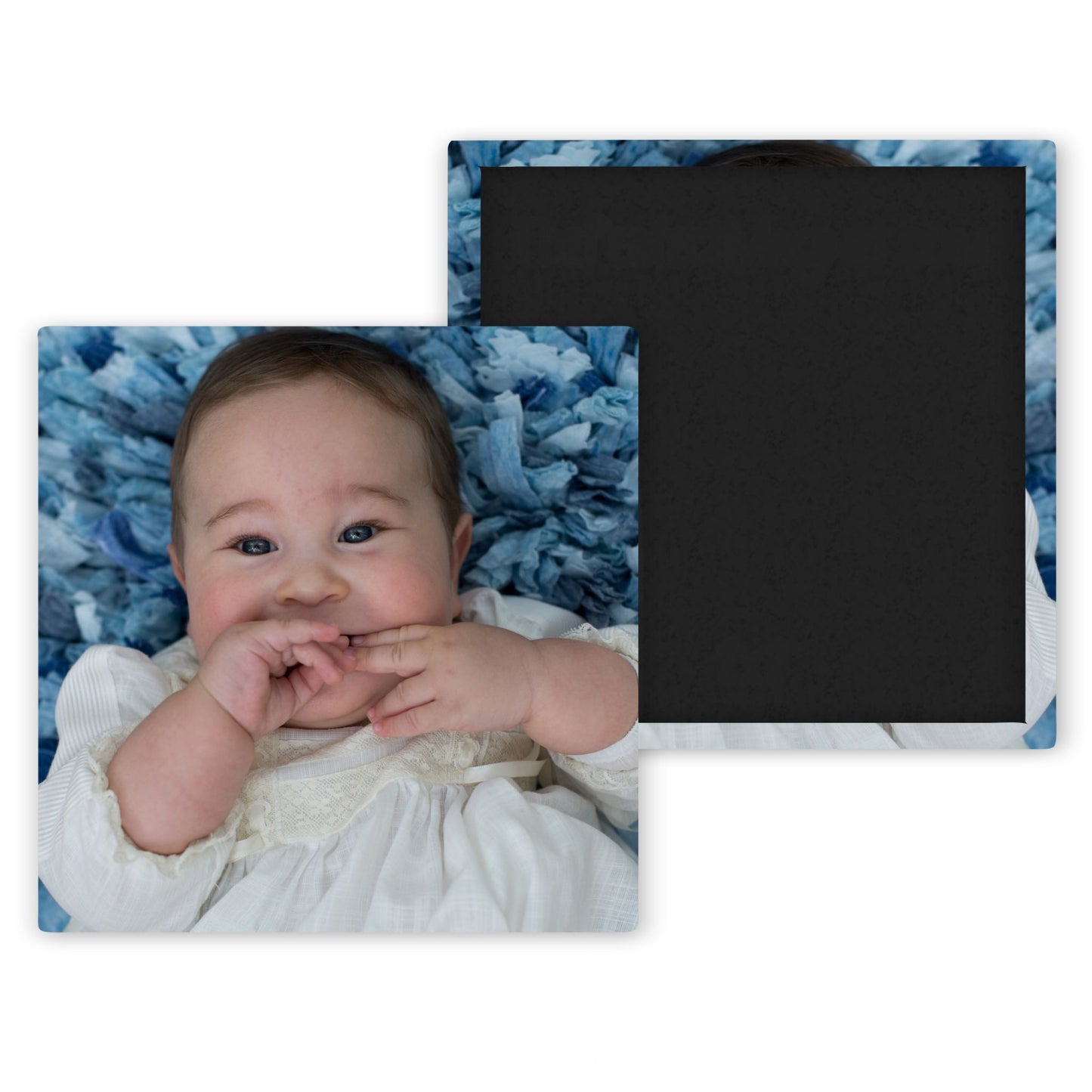 baby in white baptism gown with light blue background