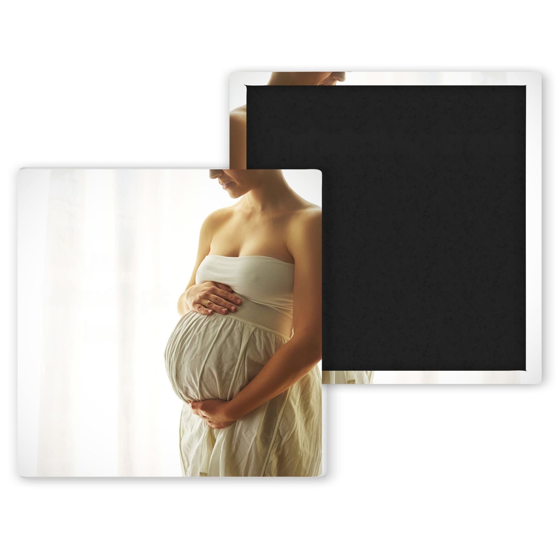 pregnant woman in white dress holding her belly