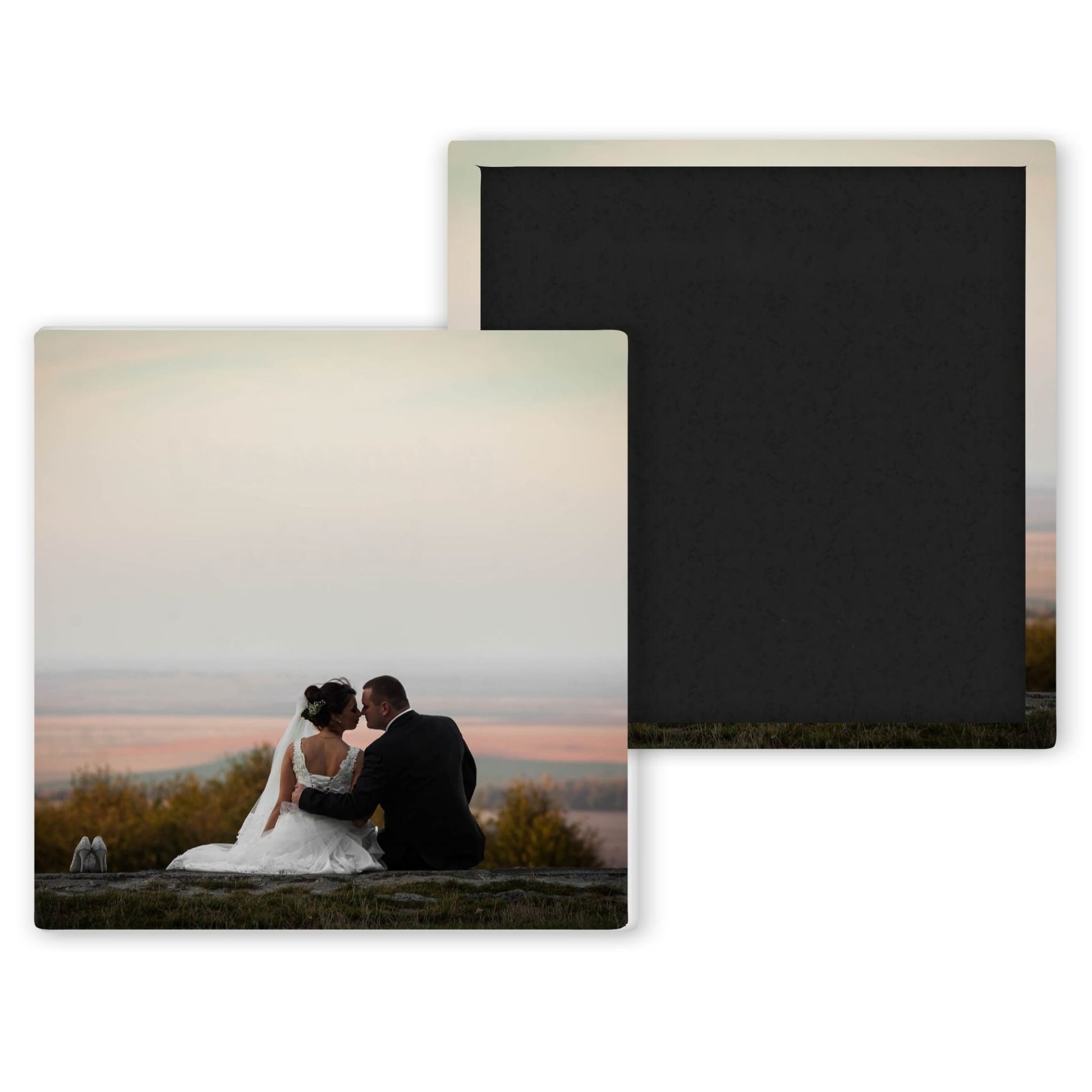 wedding photo magnet of bride and groom sitting on a field