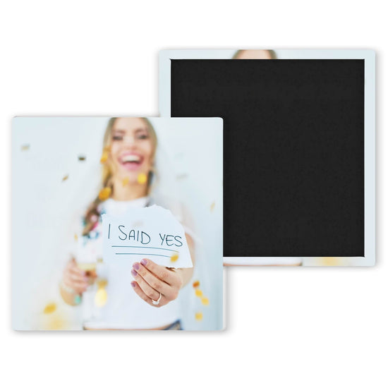 bride to be holding I Said Yes sign
